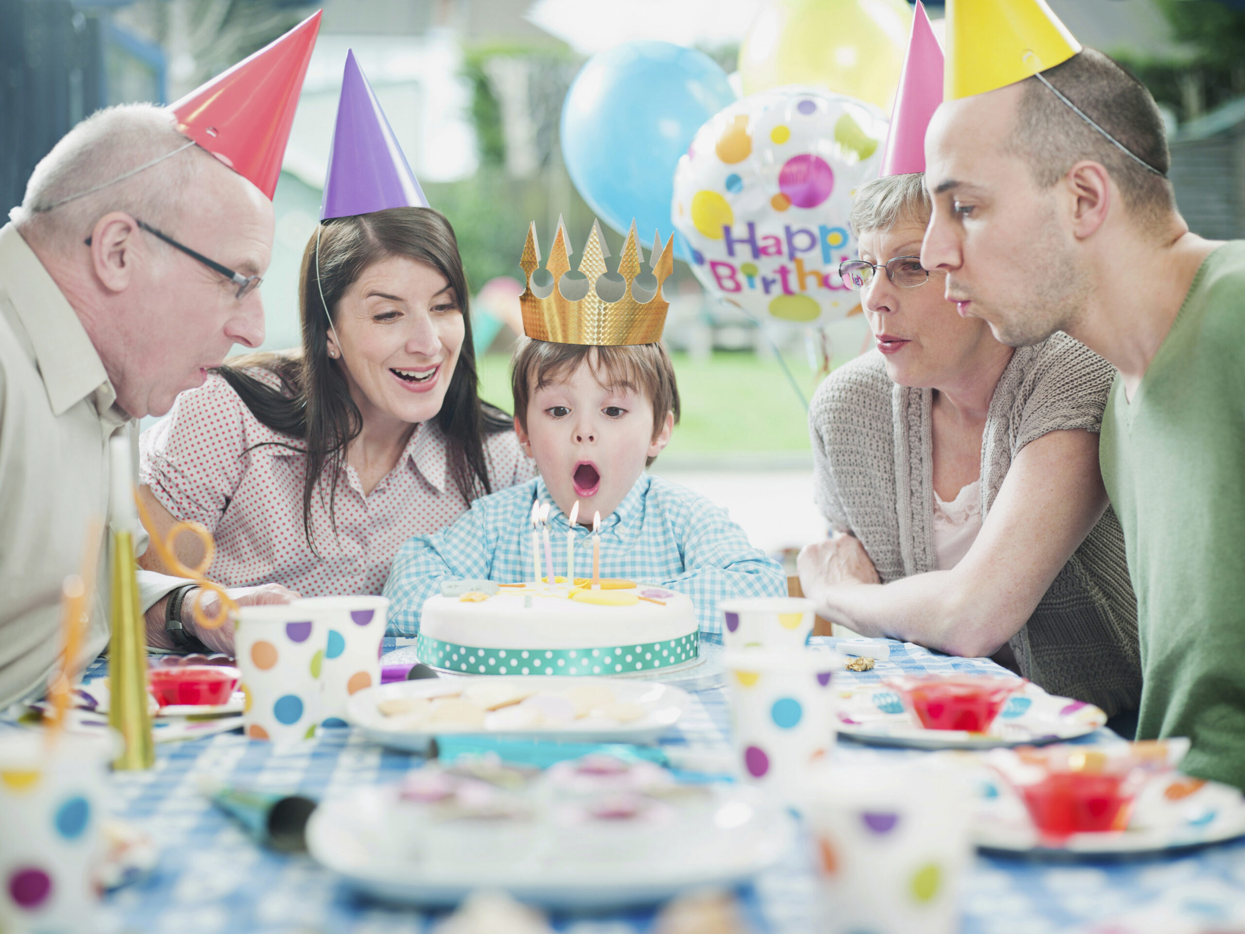 Happy Family At Childs Birthday Party, with Parents and Grandparents